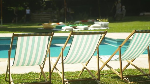 Deckchairs near swimming pool at wedding