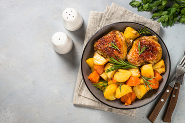 Baked chicken with vegetables top view.