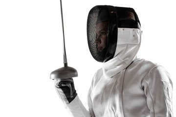 Teen girl in fencing costume with sword in hand isolated on white studio background. Young female...