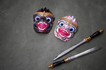 Thai traditional black and white monkey actor's mask( Hunuman and Nila) with 2 wooden swords on...