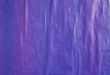 Purple blue crumpled gloss paper poster or placard glued on billboard with rough surface texture...