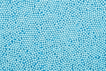 Confectionery sprinkle of blue balls background.
