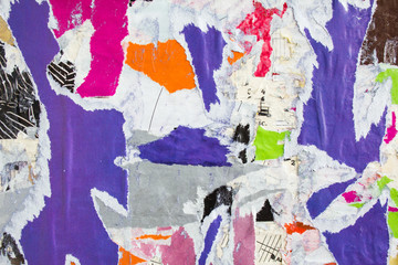 Motley torn and peeling pieces of paper posters texture background.