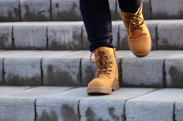 The girl makes the ascent of the stairs. A teenager walks up the stairs in the city.