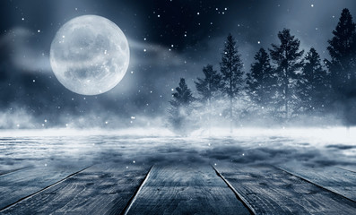 Winter background. Winter snow landscape with wooden table in front. Dark winter forest background...