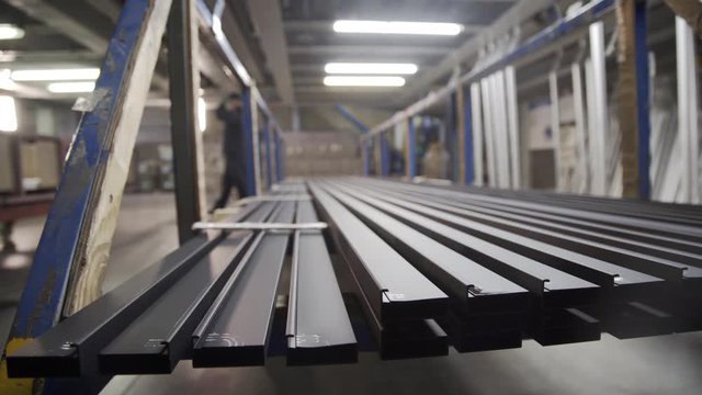 Coloured Aluminum profiles after anodizing process in the factory. Electrolytic passivation process to increase the thickness of natural oxide layer on the surface of metal parts.
