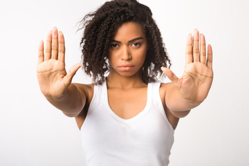 Serious black girl showing stop sign with two hands - obrazy, fototapety, plakaty