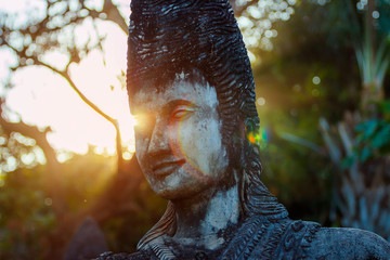 Beautiful in the rays of sunset statues of Buddhist and Hindu mythology at Wat Xieng Khuan Buddha Park. Vientiane, Laos
