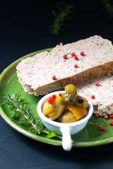 Food appertiser Concept French meatloaf Terrine or pate  in green dish with copy space
