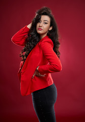 Young businesswoman on red background