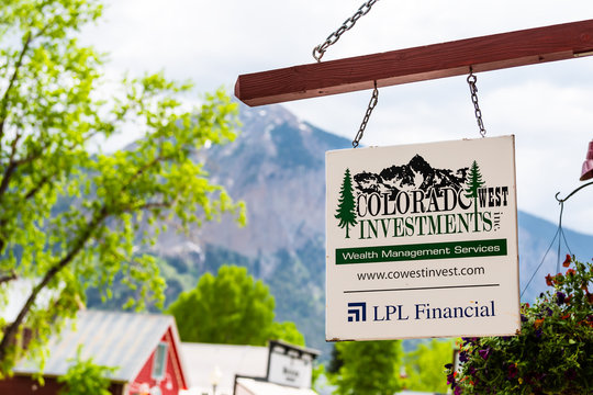 Crested Butte, USA - June 21, 2019: Colorado village downtown in summer on elk avenue with sign for wealth management investments LPL financial