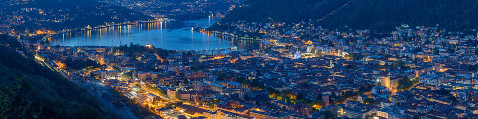 Fototapeta na wymiar Como - The city with the Cathedral and lake Como at dusk.