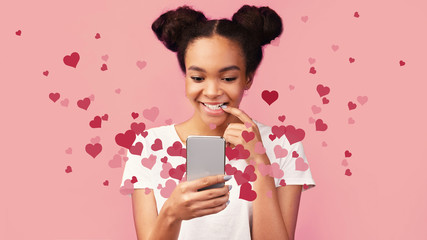 Happy black teenager excited about activity on social media