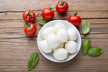 Foto op Plexiglas Small mozzarella balls, cherry tomatoes and basil. Top view. © fabiomax