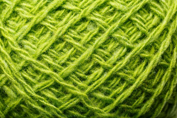Wool yarn close up colorful green threads for needlework in macro.