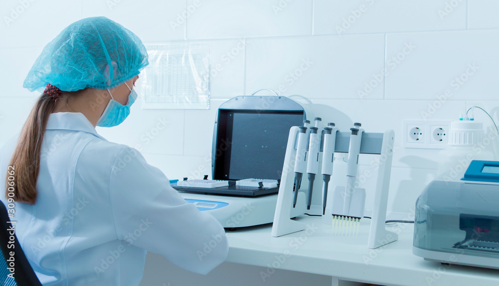 Poster young lab assistant learning how to use new equipment