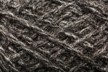 Wool yarn close-up gray threads for needlework in macro. Background texture fabric for knitting needle.