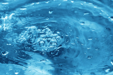 Boiling liquid with bubbles on the surface.