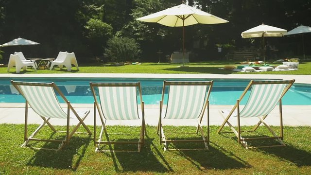Deckchairs near swimming pool at wedding