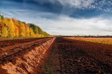 Pile of ground peat at an excavation side in a peat bog in Northwestern Germany