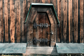 Massive wooden door with a lock. Closed door in an old wooden church