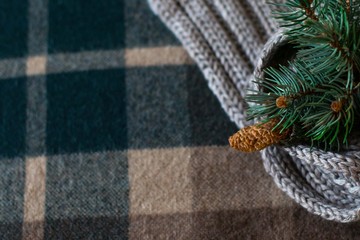 the decoration of the Christmas tree on a checkered background, a cozy blanket on Christmas