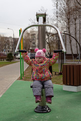 Child climbs on the Playground, entertaining sports simulators