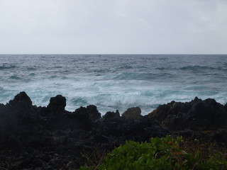 Black coastline of Maui and the ocean in the spring