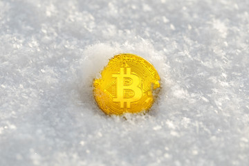 Bitcoin cryptocurrency on snow