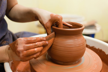 Potter gives final shape to clay product