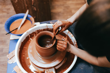 Potter gives final shape to clay product