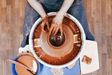 Potter gives final shape to clay product