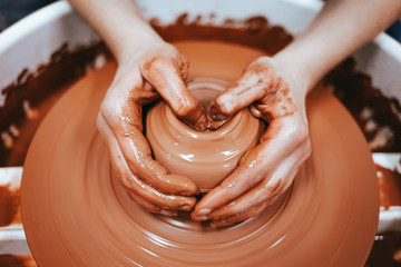 Potter forms clay products into future ceramic dishes. Process of creating clay products close-up
