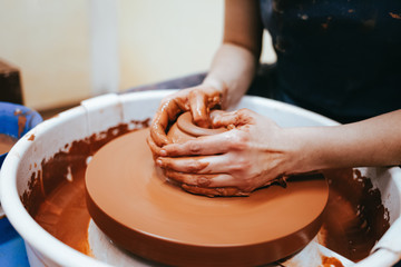 Obraz na płótnie Canvas Professional potter works on a pottery wheel