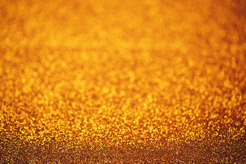Christmas abstract texture, golden sparkles bokeh shining background.