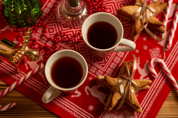 Top horizontal view of cups of black tea with Christmas decoration 