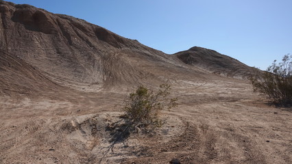 Tire tracks in the sand show people attempting steep hills in Ocotillo Wells state off-road park.