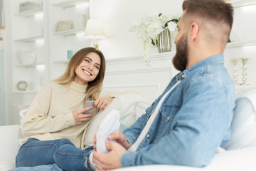 Obraz premium Loving man doing feet massage for her tender wife