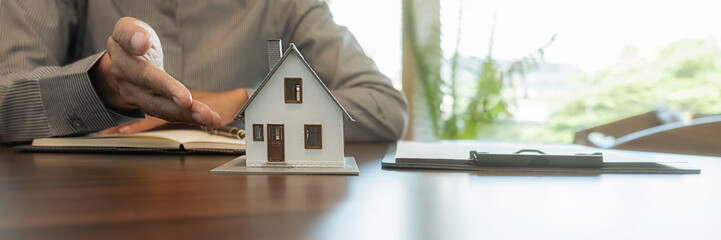 House model with agent asking costumer for contract to buy, get insurance or loan real estate or...