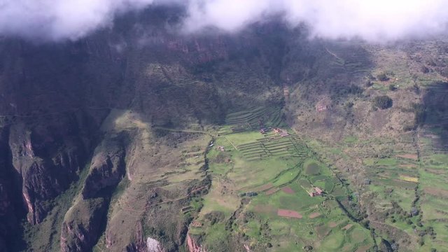 Dolly right to panoramic view the filds of agriculture on the mountain in Sacrad Valley in Cusco. 