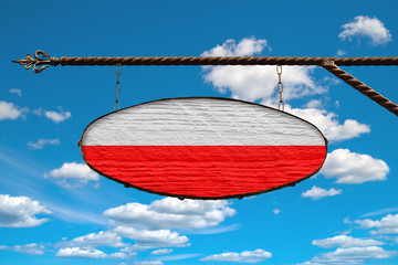 Poland flag on signboard. Oval signboard colors Poland flag hanging on a metal forged structure....