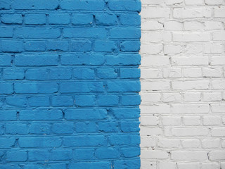 blue and white painted old brick wall
