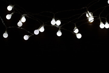 Christmas lights over wooden background, copy space