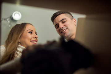 Couple opening box in new apartment