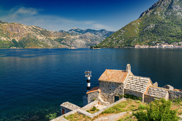 Sunny morning view of Kotor bay and coastal road near Tivat, Montenegro.