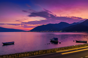 Fototapeta na wymiar Sunset view of Kotor bay and coastal road near Tivat, Montenegro.