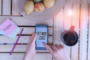 Word writing text Get More Leads. Business photo showcasing initiation consumer interest or enquiry products or services woman computer smartphone drink mug office supplies technological devices