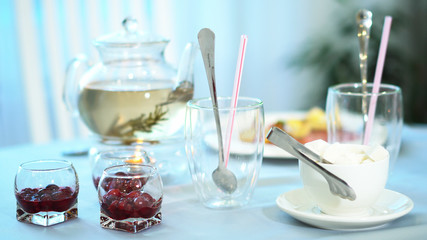 hot tea in a glass jar to enjoy the aroma and taste of the drink. Sugar and jam for tea additives.