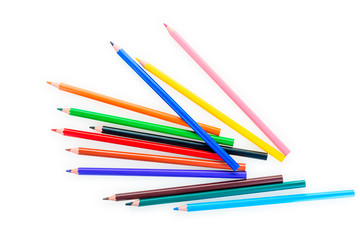 scattered set of color pencils on a white background is isolated