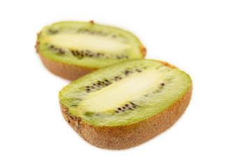 selective focus of juicy cut exotic ripe kiwi isolated on white